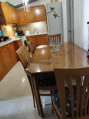a kitchen with a wooden table and wooden chairs at Georgia apartment in Chania Town