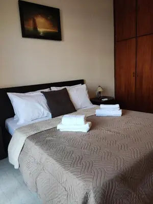 a bedroom with a large bed with towels on it at Georgia apartment in Chania Town