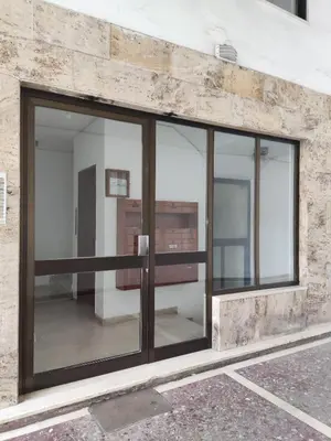 a glass door on a building with a stone wall at Georgia apartment in Chania Town