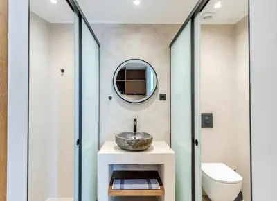 a bathroom with a sink and a mirror at VENTUS Luxury Suites in Khóra Sfakíon