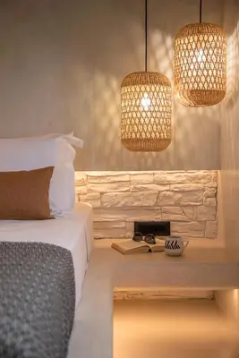 a bedroom with a bed and two pendant lights at Christini Secrets in Plátanos