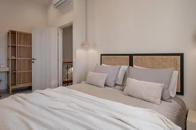 a bedroom with a large white bed with pillows at Casa Benedetta in Chania Town