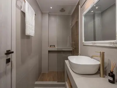 a white bathroom with a sink and a mirror at Casa Benedetta in Chania Town