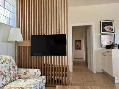a living room with a television on a wooden wall at Primavera Retreat in Chania Town