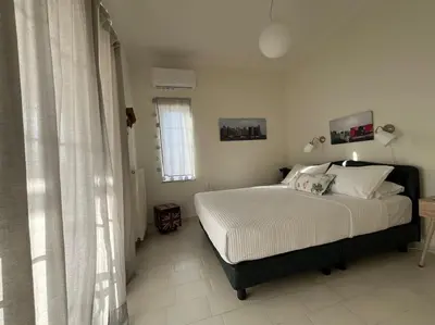 a bedroom with a bed and a window at Verano Retreat in Chania Town