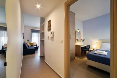 a bedroom with a bed and a living room at Cosy apartment near the beach in Chania Town