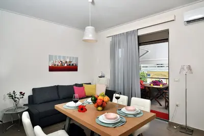 a living room with a table and a couch at Cosy apartment near the beach in Chania Town
