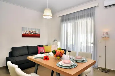 a living room with a table and a couch at Cosy apartment near the beach in Chania Town