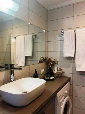 a bathroom with a white sink and a mirror at Kidonias apartment in Chania Town