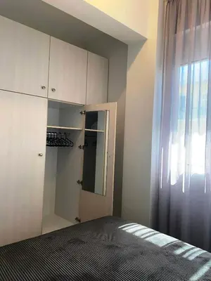 a bedroom with a bed and a closet and a window at Kidonias apartment in Chania Town