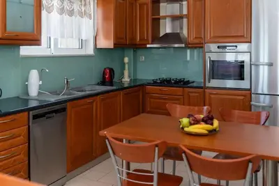 a kitchen with a wooden table with bananas on it at Bella Vista Casa in Chania Town