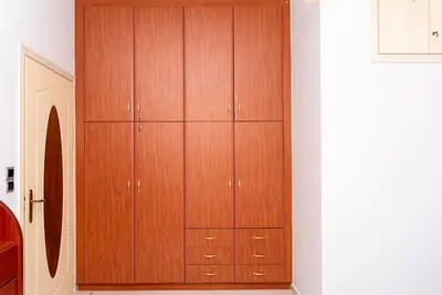 a closet with wooden cabinets in a room at Bella Vista Casa in Chania Town