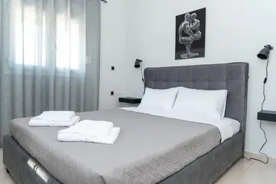 a bedroom with a large bed with two towels on it at Bella Vista Casa in Chania Town