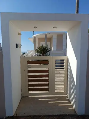 a gate leading to a house with a balcony at Bella Vista Casa in Chania Town