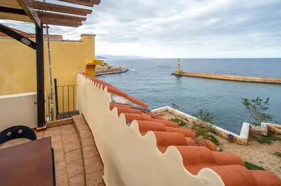 a balcony with a view of the ocean at In Heart of Old Town w. Venetian Port Views in Chania Town