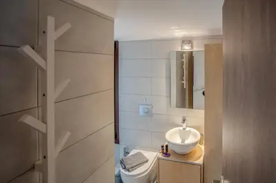 a bathroom with a sink and a toilet and a mirror at In Heart of Old Town w. Venetian Port Views in Chania Town