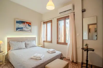 a bedroom with a bed with two towels on it at In Heart of Old Town w. Venetian Port Views in Chania Town