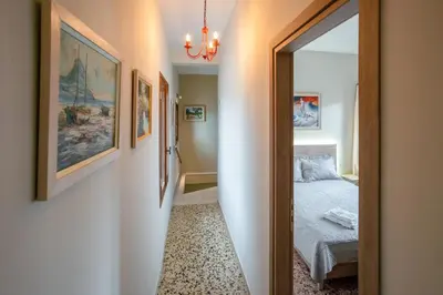 a hallway leading to a bedroom with a bed at In Heart of Old Town w. Venetian Port Views in Chania Town