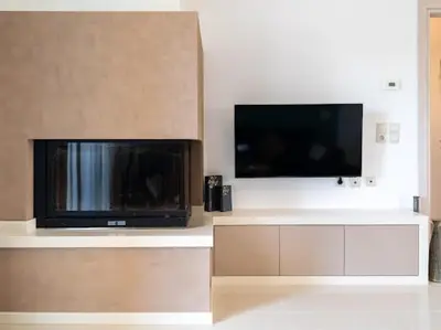a living room with a flat screen tv on a wall at Olive Grove Apartment in Chania Town