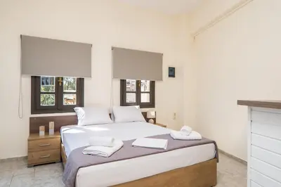 a bedroom with a bed with two towels on it at Be Crete - Solis maisonette in Chania Town