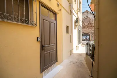an empty alley with an open door on a building at Be Crete - Solis maisonette in Chania Town