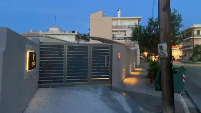 a gate on the side of a building with a street at EVAMAR, Premium Living in Chania Town