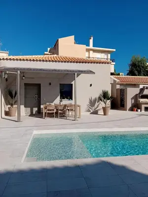 a villa with a swimming pool and a house at EVAMAR, Premium Living in Chania Town