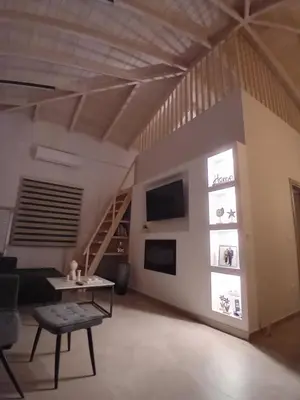 a living room with a staircase and a table at EVAMAR, Premium Living in Chania Town