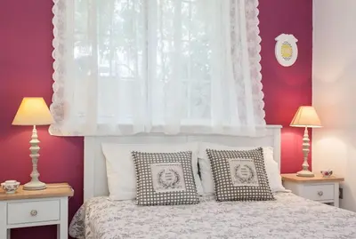 a bedroom with a white bed with two lamps at Stylish house 2 min from the beach! VERY FAST WF in Daratso