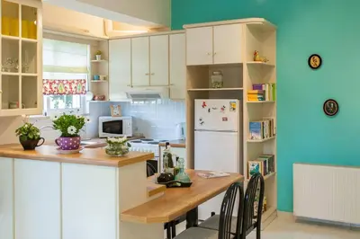 a kitchen with a table and a refrigerator at Stylish house 2 min from the beach! VERY FAST WF in Daratso