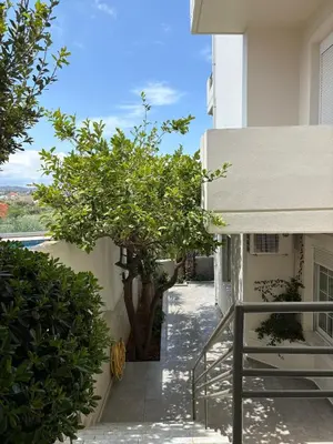 a view from the balcony of a building with a tree at Stylish house 2 min from the beach! VERY FAST WF in Daratso