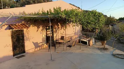 a house with a pergola with plants on it at Xanthippi's in Pemónia