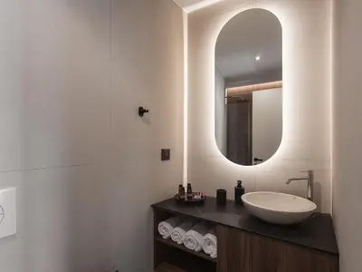 a bathroom with a sink and a mirror at Copal Simple Staying in Chania Town