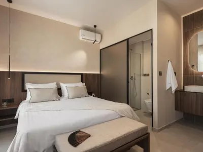 a bedroom with a large bed and a bathroom at Copal Simple Staying in Chania Town