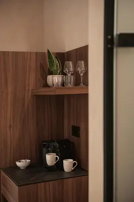 a shelf with cups and wine glasses on it at Copal Simple Staying in Chania Town