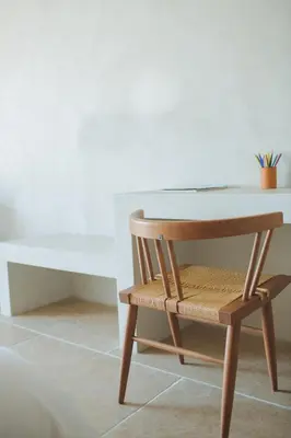 a wooden chair sitting next to a table and a desk at The Theodore Boutique Hotel- adults only 16 plus in Agia Marina Nea Kydonias
