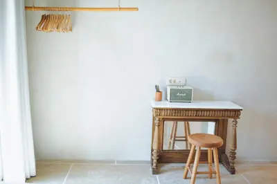a small table with a stool and a microwave on it at The Theodore Boutique Hotel- adults only 16 plus in Agia Marina Nea Kydonias