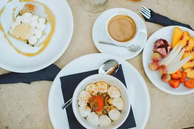 a table with plates of food and a cup of coffee at The Theodore Boutique Hotel- adults only 16 plus in Agia Marina Nea Kydonias