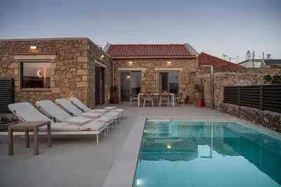 a patio with chairs and a swimming pool at Casa Nougia in Chania Town