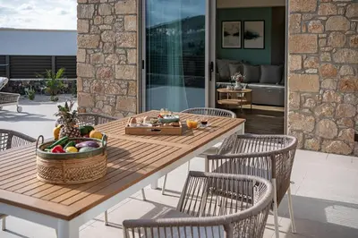 a wooden table with a basket of fruit on a patio at Casa Nougia in Chania Town