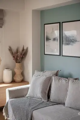 a bedroom with a bed with two pictures on the wall at Casa Nougia in Chania Town