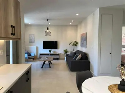a living room with a couch and a tv at Stefania's House in Chania Town
