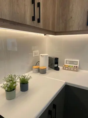 a kitchen counter with three potted plants on it at Stefania's House in Chania Town