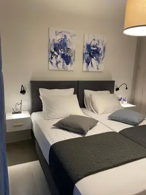 two beds in a bedroom with two pillows at Stefania's House in Chania Town