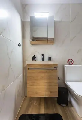 a bathroom with a sink and a vanity with a mirror at Splatzia old town maizonette in Chania Town