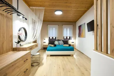 a bedroom with a bed and a sink in a room at Splatzia old town maizonette in Chania Town