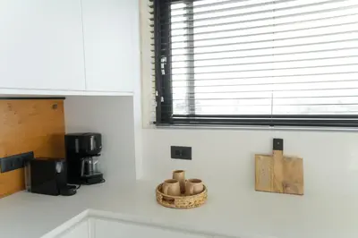 a kitchen counter with a coffee maker and a window at Hygge Villa Evgenia in Kounoupidhianá