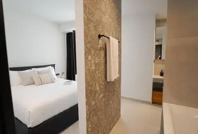 a hotel room with a bed and a bathroom at Hygge Villa Evgenia in Kounoupidhianá