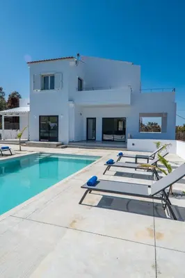 a villa with a swimming pool and a house at Montis villa sea view heated pool in Daratso