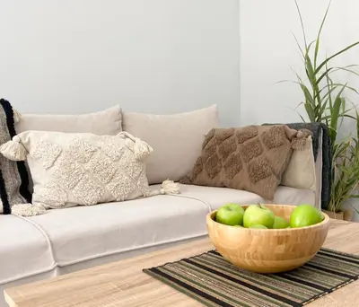 a living room with a couch and a bowl of apples at YVONNE's HOUSE in Chania Town